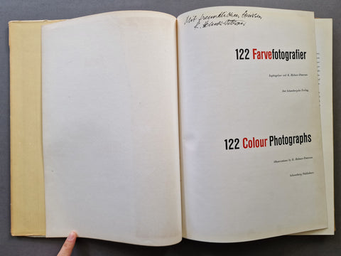 An open book spread showing the title page of 122 Colour Photographs by Keld Helmer-Petersen with is signature and inscription at the top of the page.