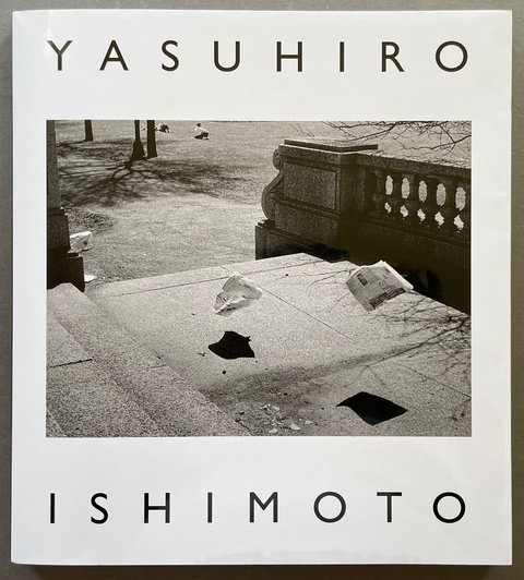 A square book or print cover with a white border, featuring the text 'YASUHIRO' at the top and 'ISHIMOTO' at the bottom in large black letters, surrounding a black-and-white photograph of stone steps and a balustrade.