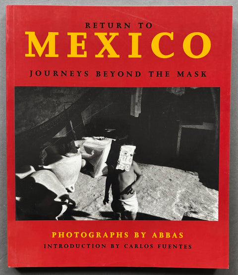 Book titled 'Return to Mexico: Journeys Beyond the Mask' by Abbas with a red cover featuring an image from the content of the book.
