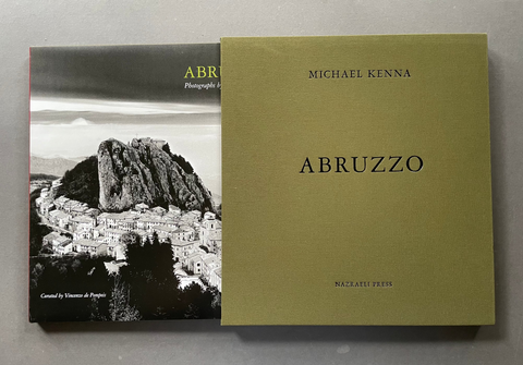 A black-and-white photography book titled ABRUZZO with a mountain town photo cover, and an olive-green slipcase.