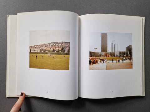 An open book showing two printed photographs on the pages