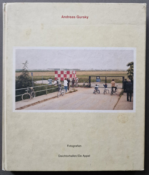 The photobook cover of Andreas Gursky Fotografien in off white with a photo of a park scene with lots of people on bikes.