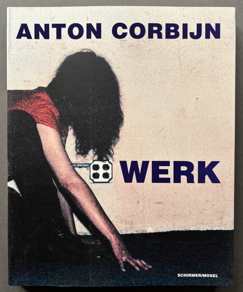 Book titled 'Werk' by Anton Corbijn with a cover featuring the image of a woman crawling on the floor in front of a plug socket.