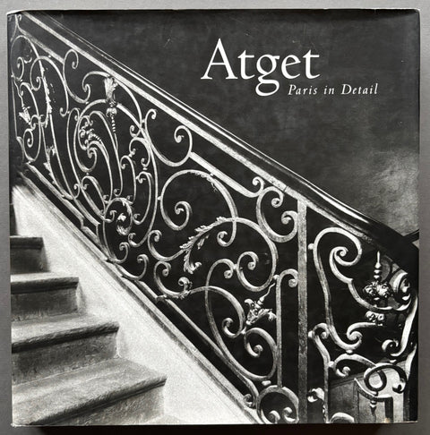 Book titled 'Atget: Paris in Detail' by Eugene Atget with a cover featuring the image of an ornate banister.