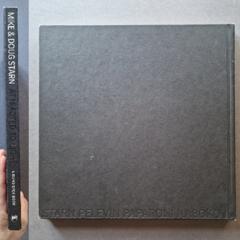 The spine and back cover of Attracted To Light by Doug and Mike Starn