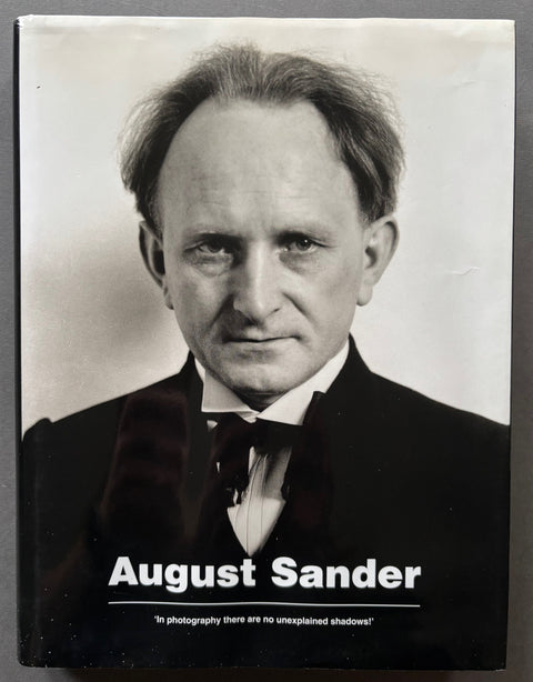 Book titled 'In Photography There Are No Unexplained Shadows' by August Sander with a cover featuring a black and white image of the artist.