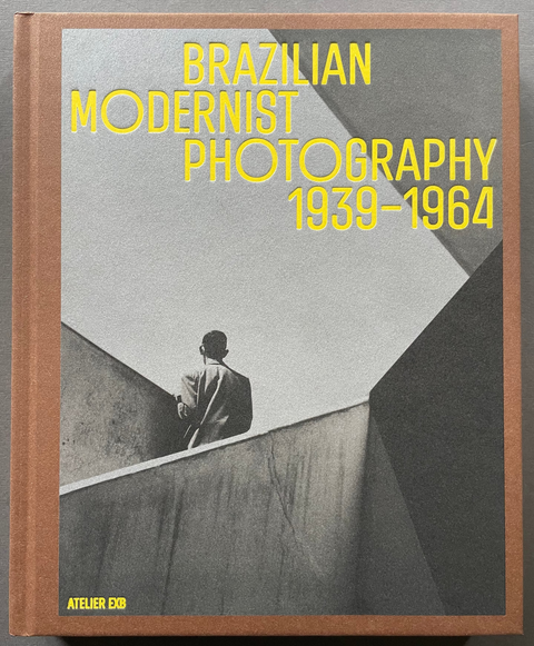 Front cover of Brazilian Modernist Photography 1939-1964 with a black and white image of a man standing on a staircase.