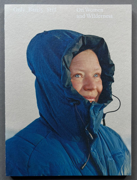 Book titled ' Only Barely Still - On Women and Wilderness' by Catherine Lemble with a grey cover featuring the image of a woman in a blue coat.