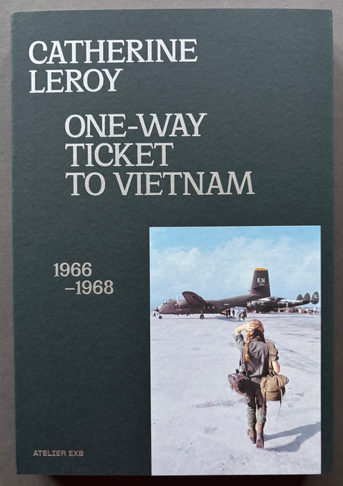 Book titled 'One Way Ticket to Vietnam' by Catherine Leroy with a black cover featuring the image of a woman walking towards a military aircraft.