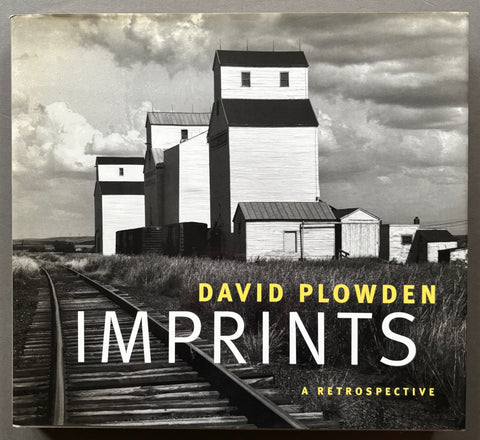 Book titled 'Imprints: A Retrospective' by David Plowden with a cover featuring the image of buildings next to a railway track.