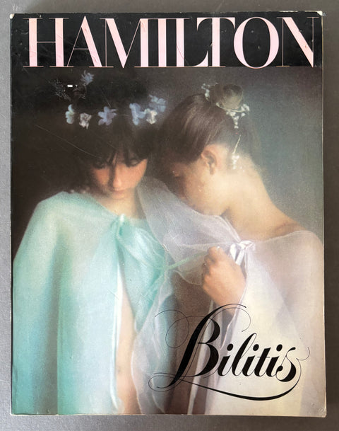 Vintage fashion magazine cover titled HAMILTON with the subtitle Bilitis, featuring two women in flowing sheer white and pale blue garments against a dark background.