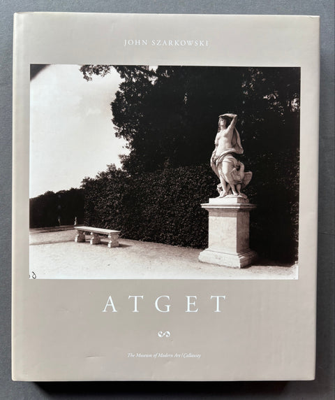 Book cover with black and white photo of a statue and trees, featuring the brand 'Atget'.