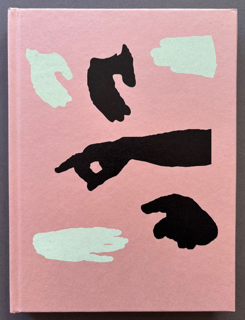 Book titled 'Italia O italia' by Federico Clavarino with a pink cover featuring hands in black and white.