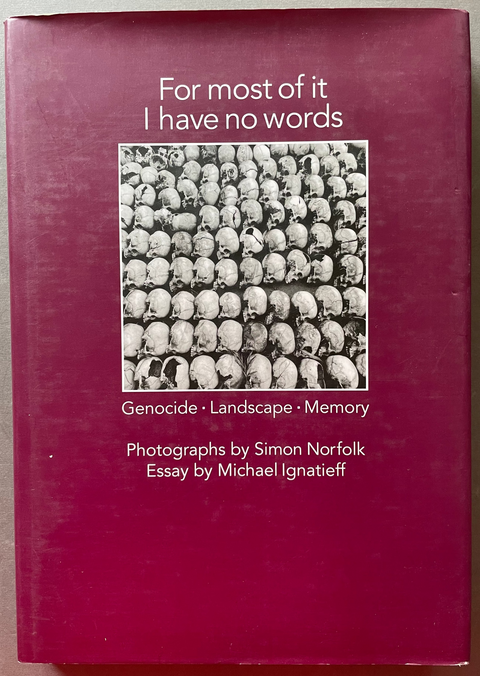 Front cover for For most of it I have no words by Simon Norfolk with a black and white image of human skulls.