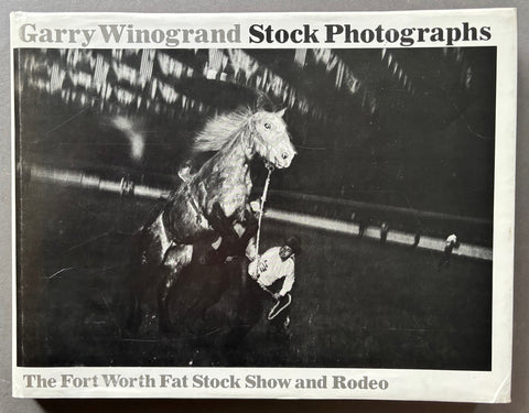 Book titled ' Stock Photographs: The Fort Worth Fat Stock Show and Rodeo with a white cover featuring the image of a horse rearing up on its hind legs.