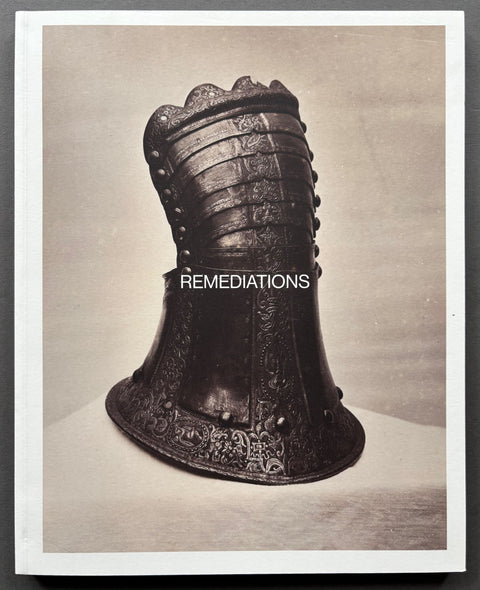Book titled 'Remediations' with a white cover featuring the photograph of a metallic object of art.