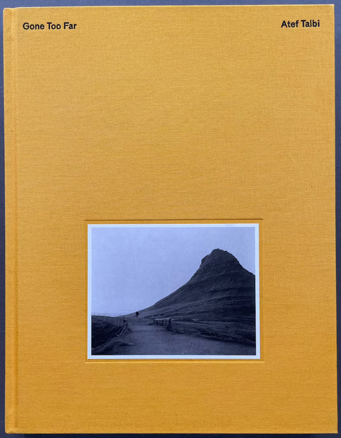 A book cover for 'Gone Too Far' by Atef Talbi, featuring a textured mustard yellow cover with a central square inset photograph of a mountain landscape.