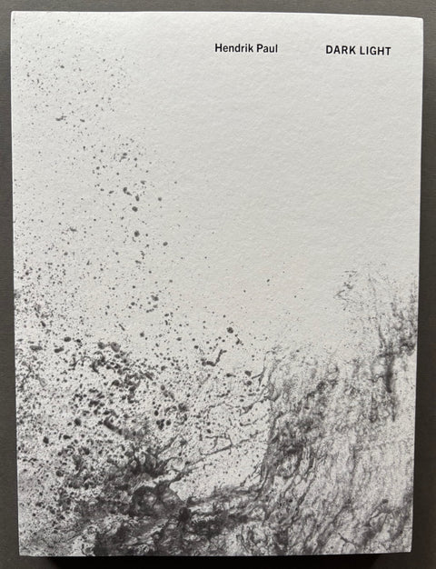 Book titled 'Dark Light' by Hendrik Paul with a white and grey cover.