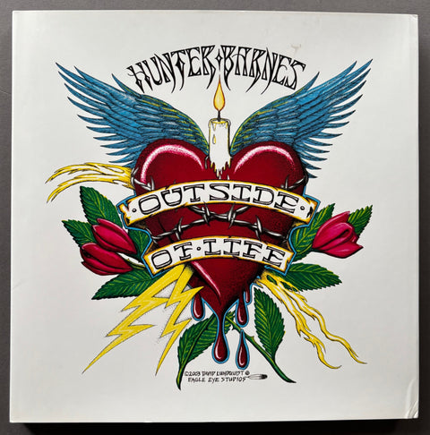 Book titled 'Outside of Life' by Hunter Barnes with a white cover featuring an image of a tattoo comprised of a bleeding heart, angel wings, a candle and flowers.