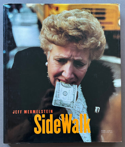 Book titled 'Sidewalk' by Jeff Mermelstein with a cover featuring the image of a woman with a ten dollar bill between her teeth,