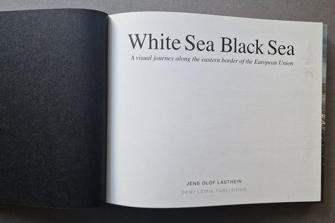 An open book. The right page contains the title 'White Sea Black Sea' with smaller subtitle text and publisher text near the bottom.