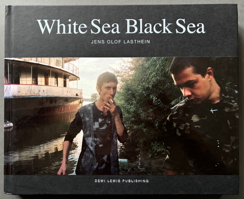 Book titled 'White Sea Black Sea' by Jens Olof Lasthein with a cover featuring 2 men and a boat on body of water.