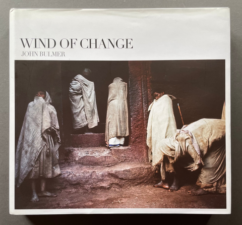 Wind of change by John Bulmer front cover with a color photo of young men standing on stairs.