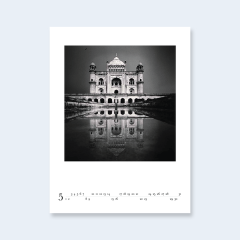 A minimalist calendar page featuring a photograph of the Taj Mahal reflected in water.