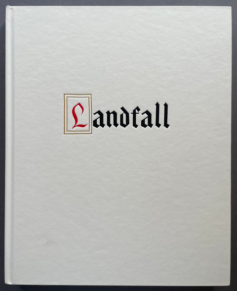 A square white book or album cover with the word 'Landfall' printed in black gothic font, with a red stylized 'L' inside a thin gold-bordered square at the beginning of the title, photographed against a dark gray background.