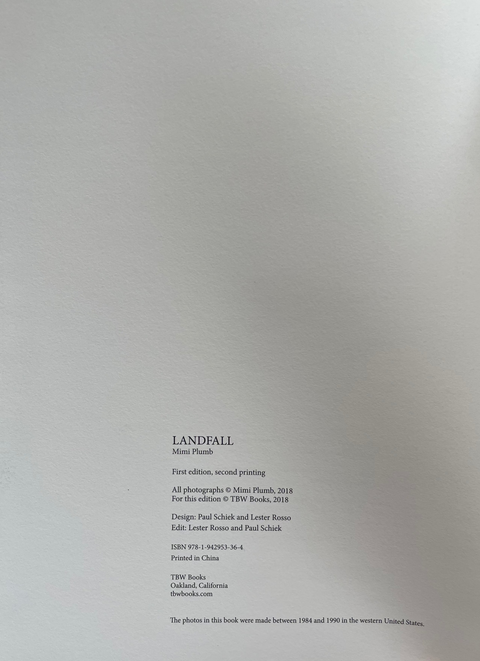 A close-up of a book's printed title page showing the title 'LANDFALL' and publication details in black text on a white page.