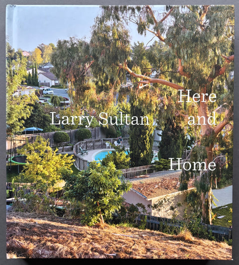 Book titled 'Here and Home' by Larry Sultan with a cover featuring an image of gardens and houses.