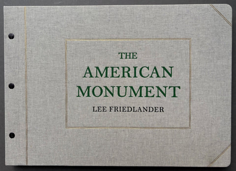 Book titled 'The American Monument' by Lee Friedlander with a grey cover and green type.