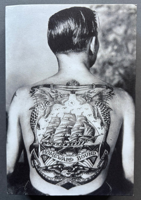 Book titled 'Love You Always: A Sentimental Journey into the Ocean of Sailors and Photography' by Laura Leonelli with a cover featuring the black and white image of a man's tattooed back.