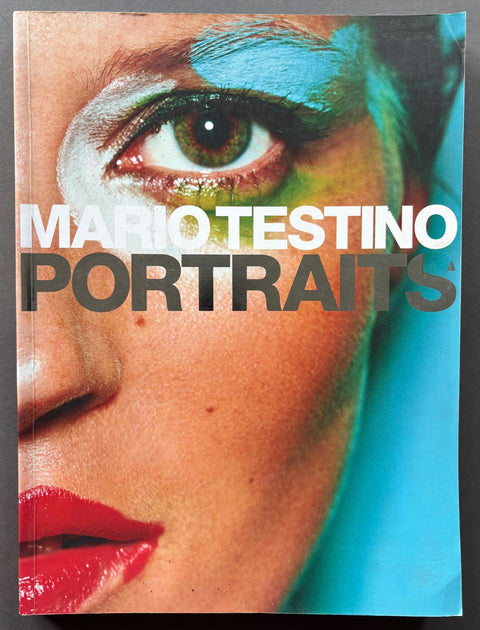 Book titled 'Portraits' by Mario Testino with a cover featuring a close up image of Kate Moss's face.