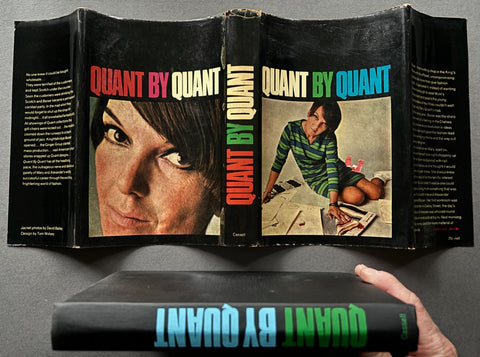 Book titled 'Quant by Quant' by Mary Quant with a cover featuring an image of the fashion designer herself.