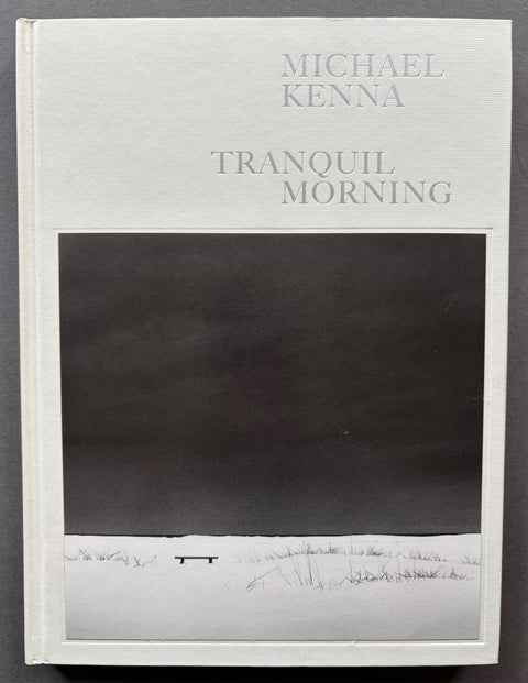 Book titled 'Tranquil Morning' by Michael Kenna with a white cover featuring an image of a snow covered ground and an expanse of sky.