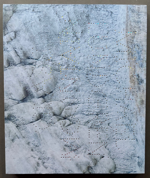 Book titled 'Glass Mountian' by Michael Lundgren with a cover featuring the image of the surface of a mountain with embossed type.