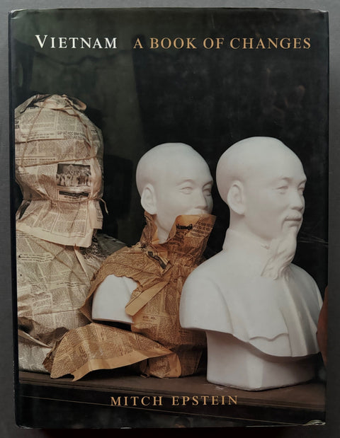 Book titled 'Vietnam: A Book of Changes' by Mitch Epstein with a black cover featuring an image of the busts of oriental men, made of porcelain, wrapped in newspaper.