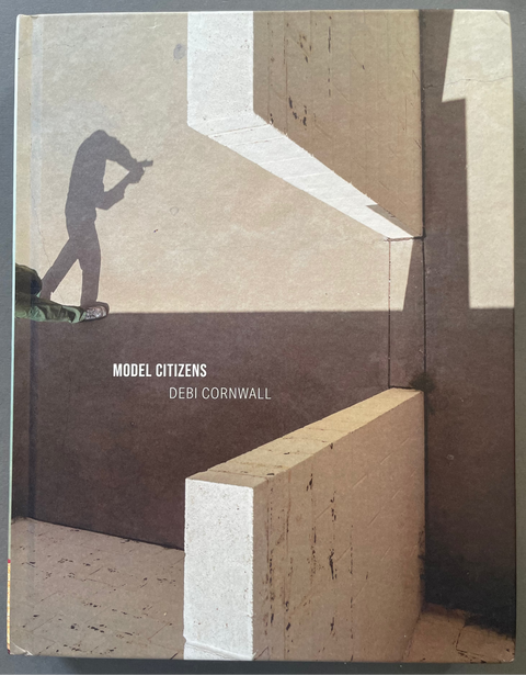 Front cover of Model Citizens by Debi Cornwall with a color aerial image of a soldier's shadow.