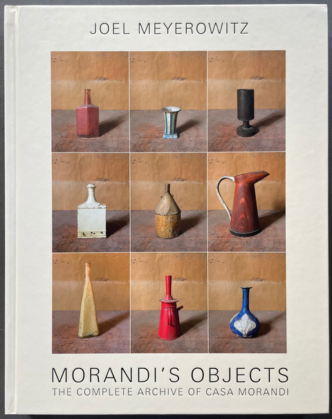 The front cover of the book 'Morandi's Objects: The Complete Archive of Casa Morandi by Joel Meyerowitz, featuring a 3x3 grid of ceramic vases and vessels in warm earth tones on a light beige cover.
