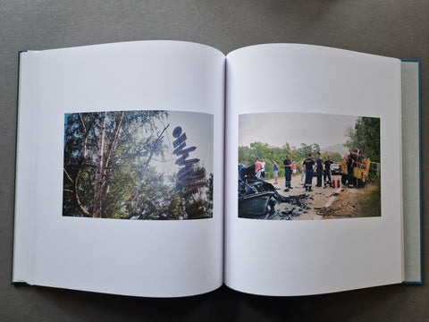 An open book showing two printed photographs spread across the white pages.