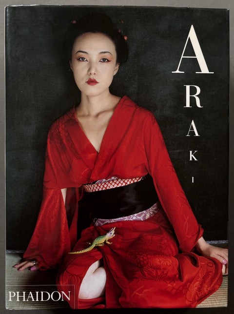 Book titled 'Moi, La Vie, La Mort' by Nobuyoshi Araki featuring a Japanese woman dressed in red on the front cover and a white flower on the back cover.