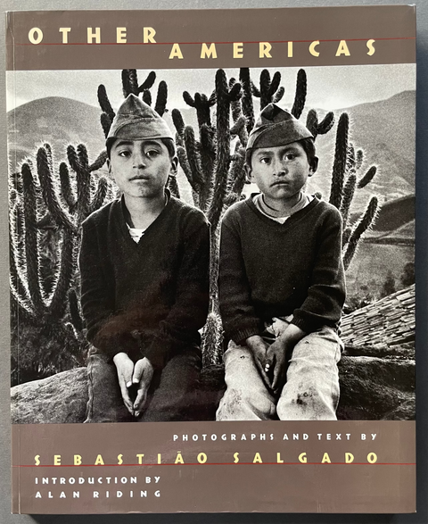 The book cover of 'Other Americas' by Sebastão Salgado, featuring a black and white photograph of two boys in a desert landscape with cacti, set against a gray background.