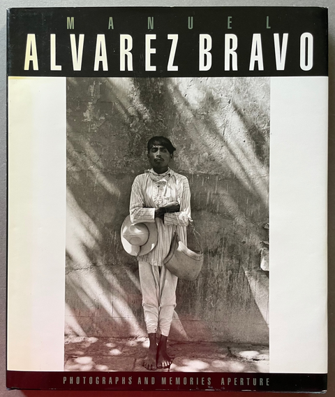 Front cover of Photographs and Memories by Manuel Alvarez Bravo wiht a black and white image of man standing next to a wall.