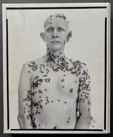 Book titled 'Portriats' by Richard Avedon with a whte cover featuring a man with a naked chest covered in bees.