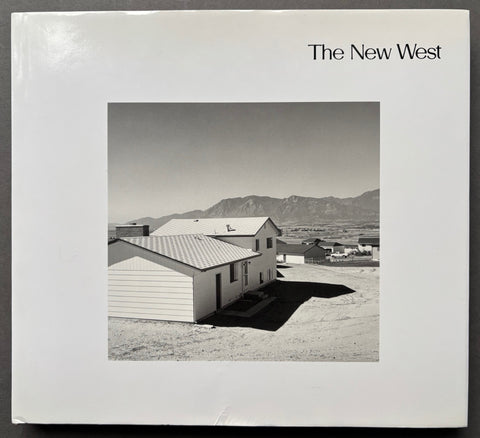 Book titled 'The New West' by Robert Adams with a white cover featuring an image of houses and hills.