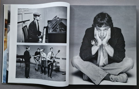 An open book spread showing black-and-white photographs of a seated man in a dark jacket and jeans, with smaller inset photos of a man playing a piano and standing with musical instruments.