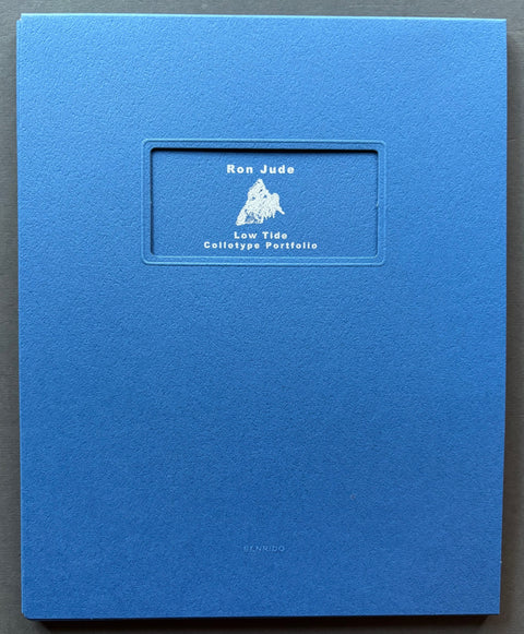 Book titled 'Low Tide' by Ron Jude with a blue cover.