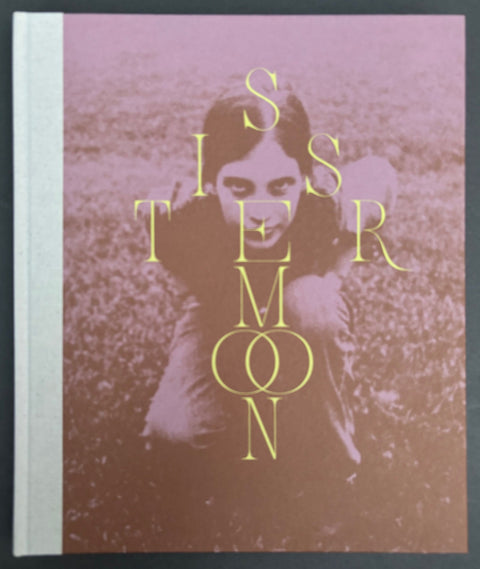 Book titled 'Sistermoon' by Siri Kaur with a cover featuring a black and white image of a girl crouching in some grass.