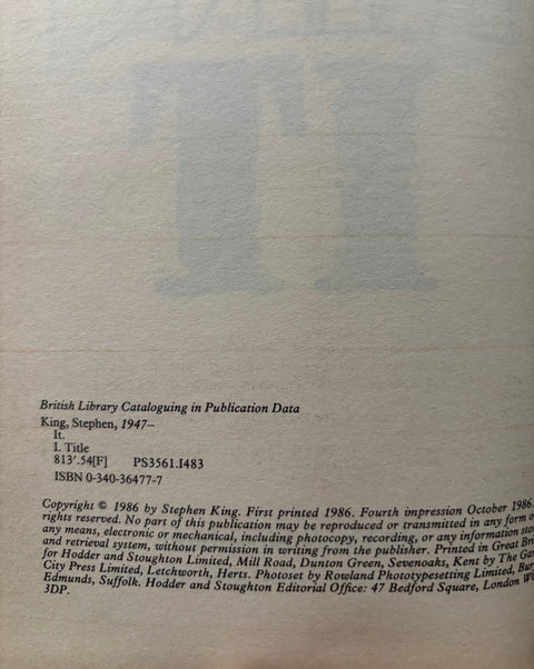 A close-up of a book's printed catalog page showing title, author, publication data, and copyright information on aged off-white paper.
